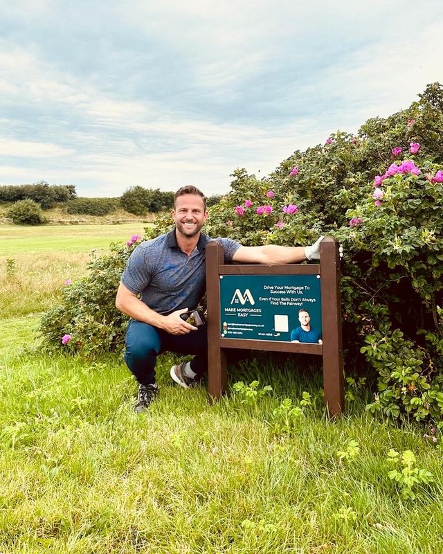 Tom Williams beside a Make Mortgages Easy sign on a local Wirral golf course
