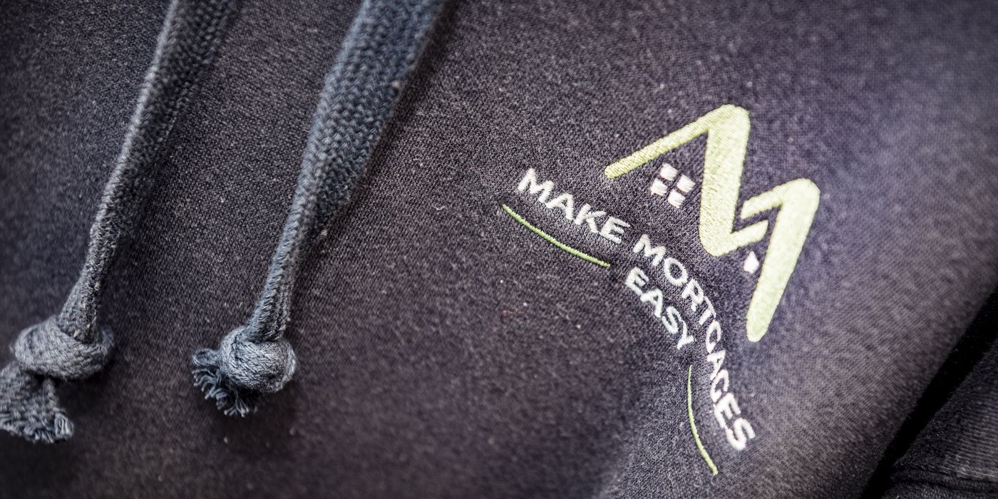 The Make Mortgages Easy logo embroidered on a jumper